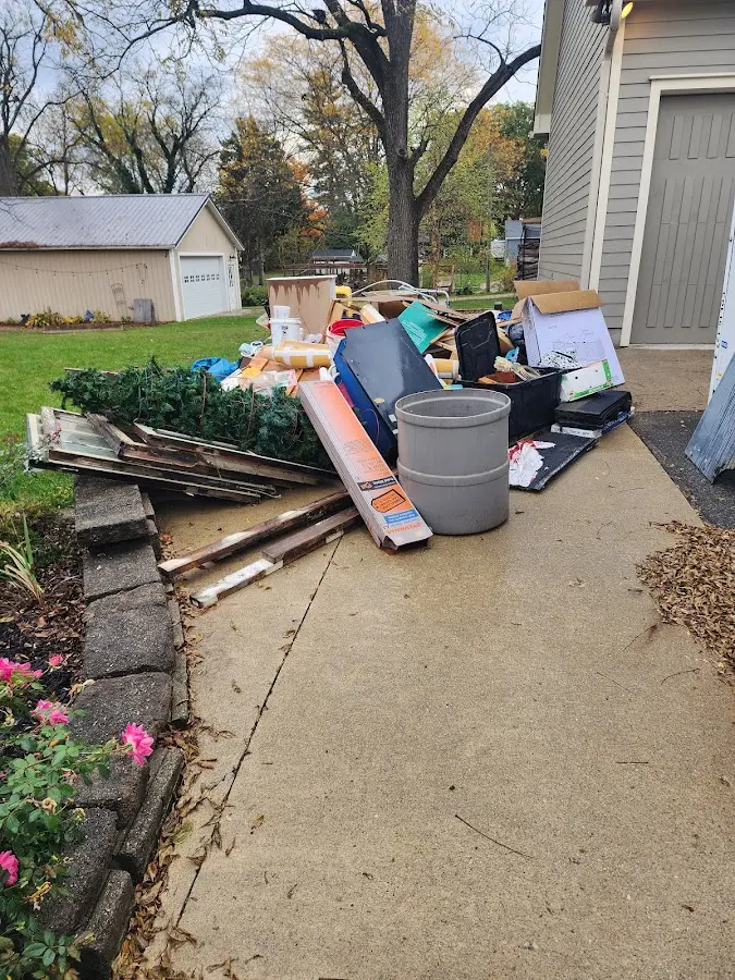 Dumpster being loaded with debris for Residential Dumpster Rental in West Point